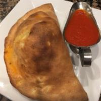 Calzone with Sausage - Served with Sauce · Calzone with Sausage, pizza dough pocket filled with seasoned whole milk ricotta and mozzare...