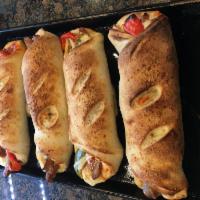 Sausage and Pepper Roll - Served with Sauce · With Italian sausage, fresh peppers, onions, mozzarella cheese and a touch of tomato sauce.
