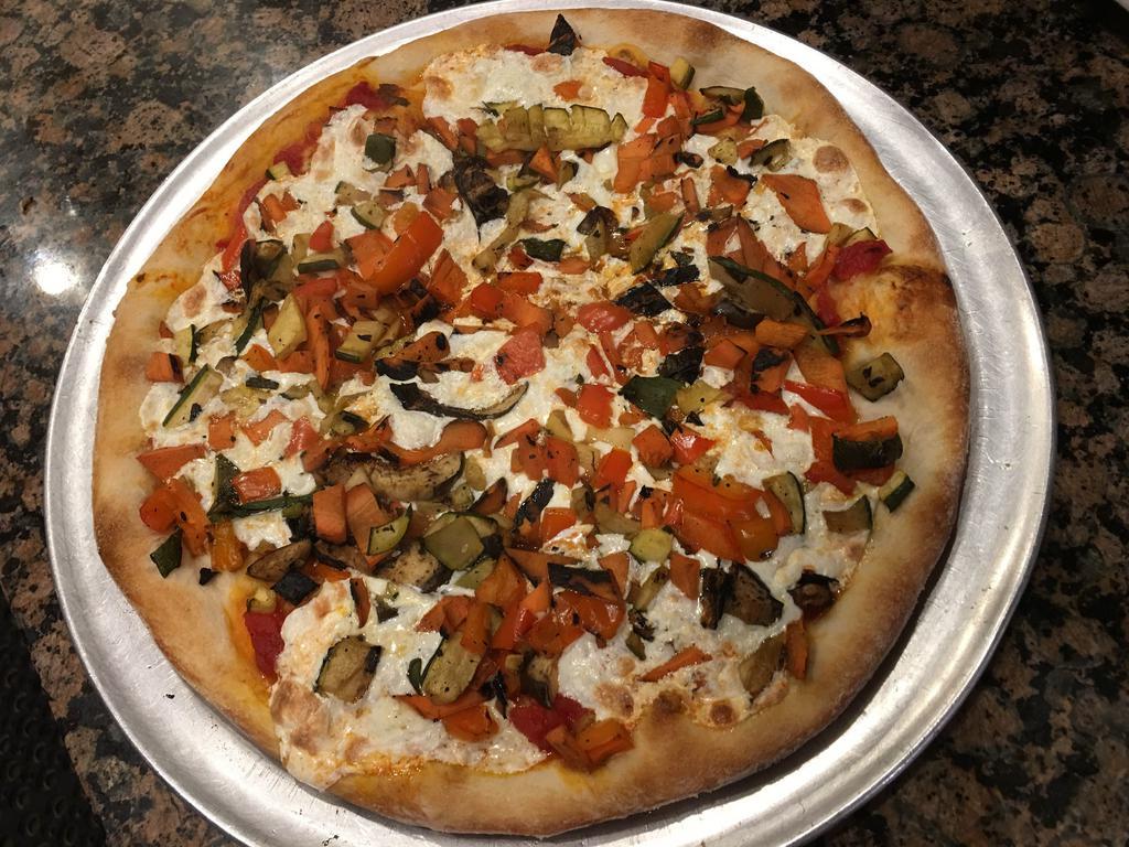 Grilled Primavera Pizza · Fresh mozzarella and plum tomato sauce topped with grilled veggies and basil.