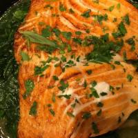 Salmon over Spinach · Grilled Salmon over a bed of Spinach, Served with your choice of side, Pasta or Salad and Br...
