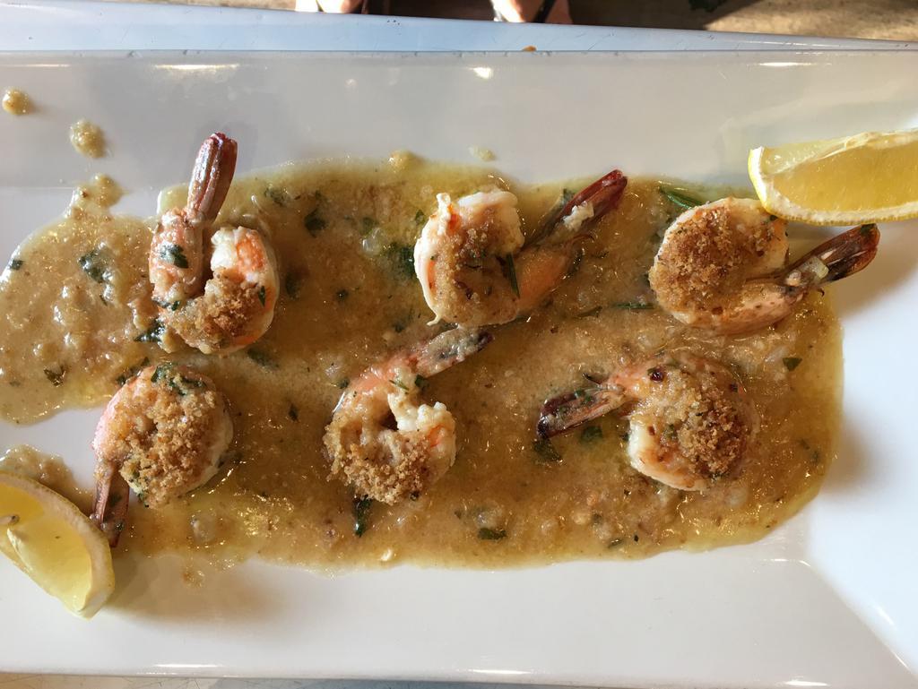 Shrimp Oreganata · Baked with breadcrumbs, butter wine, lemon, garlic and olives oil. Served with your choice of side, Pasta or Salad and Bread.
