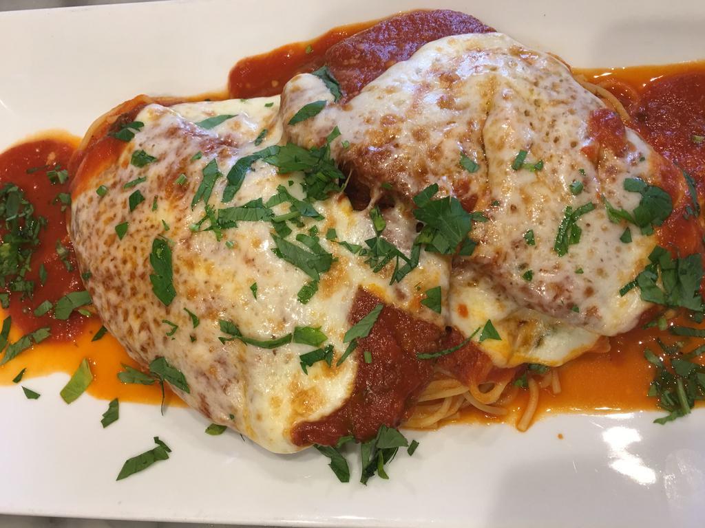 Veal Parmigiana · Veal Parmigiana dinner is served with bread, choice of pasta, salad or vegetable of the day
