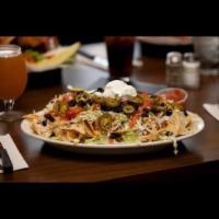 Mc Nacho's · A huge serving of crispy tortilla chips covered with nacho cheese, chili, lettuce, jalapenos...