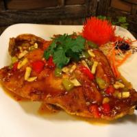 Pla Rad Prik · Deep-fried whole trout with chopped bell pepper, baby corn, mushroom, onion and basil topped...