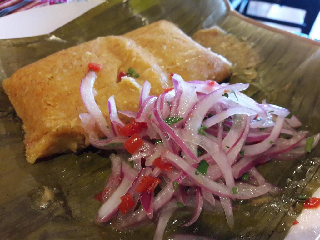Tamales  · Pork or chicken homemade Peruvian tamales served with a side of salsa criolla. 