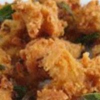 Onion Pakora · Fresh sliced onions dipped in lentil batter and deep-fried.