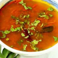 Rasam · Soup of tomatoes cooked with tamarind sauce tempered with red chilliees, onions and mustard ...