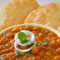 Chole Bhatura · Fluffy fried bread served with chickpeas masala with onions, tomatoes, and spices.