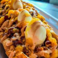Colombian Hot Dog · Pink sauce, potato stick, bacon, pineapple, sauce, and quail eggs.