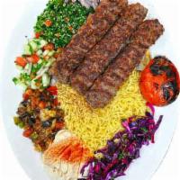 Beef kebab  · 3 skewers of Marinated ground beef, served witH rice and  bread. Comes with a side of salad ...
