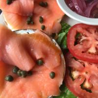 Fish Bagel · Nova lox or whitefish spread, tomatoes, pickled onions, capers and olives.