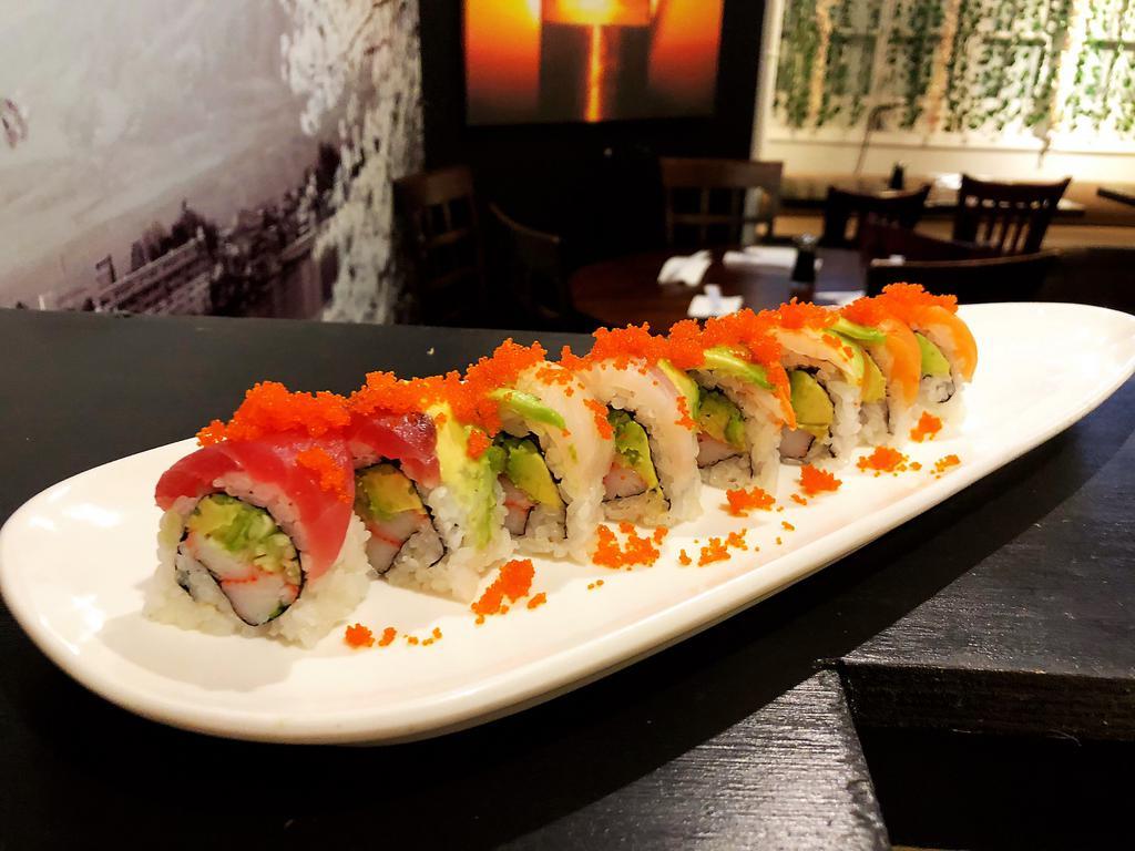 RAINBOW ROLL · Kani, and cucumber topped with avocado,  tuna, salmon and white fish.