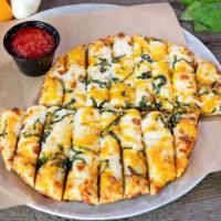 Knickerbocker Cheesy Bread · Our famous pizza dough (made fresh daily), topped with hand-grated mozzarella, cheddar chees...