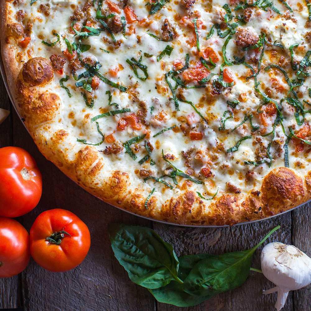 The Pearl Pizza · (White pie) Blend of oils, Parmesan, ricotta, Italian sausage, tomatoes, minced garlic and fresh basil.