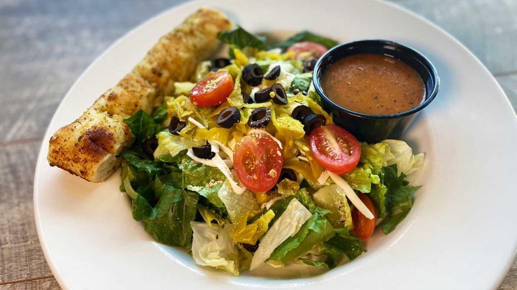 House Salad · Garden fresh mixed greens, pepperoncini, black olives, and grape tomatoes, topped with Parry’s Parmesan mix, hand-grated mozzarella, and Italian dressing served with a homemade breadstick. Add protein for an additional charge. 