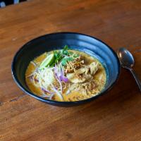 N6. Kao Soy · A Northern Thai specialty, egg noodles with combination of red and yellow curry, garnished w...