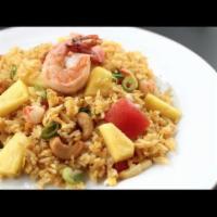 R2. Pineapple Fried Rice · Served with egg, pineapples, onions, tomatoes, cashew nuts, raisin and mixed peas and carrots.