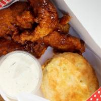 BBQ Tenders Box · Fried Tenders tossed in our house-made BBQ Sauce. Served with a biscuit and two dipping sauc...