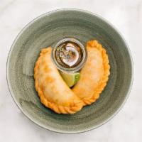 Ropa Vieja Empanadas · Golden crispy pastry ﬁlled with ﬂank steak slow-braised in Marabu Criolla sauce with sweet p...