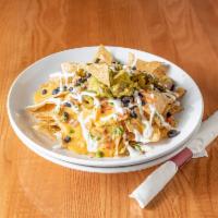 Ultimate Nachos · Choice of seasoned steak, grilled chicken or pork with black beans, melted colby cheese, pic...