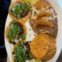 taco dinner · choice of three tacos any meat. comes with onions and cilantro served with rice and bean.