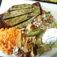 Carne Rey del Taco · Charbroiled skirt steak with pico de gallo and grilled cactus. Served with rice, beans, sala...
