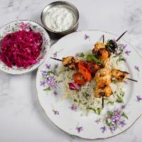 Chicken Kebab · grilled chicken marinated in house-made spice blend, served over herbed rice, grilled vegeta...