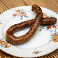 Merguez Sausage Side · Home-made spicy lamb and beef sausage.
