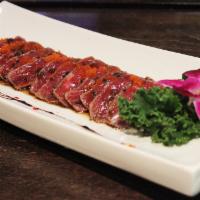 11. Beef Tataki · New York oxi Strip steak, HBQ steak with chef special sauce, masago and scallion on top.