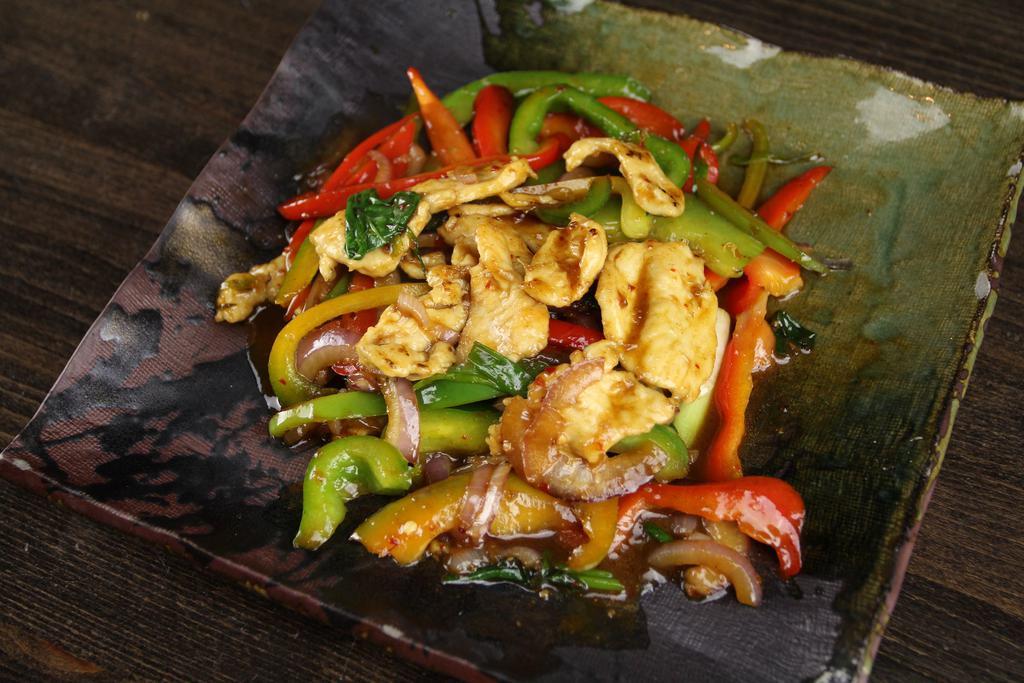 9. Thai Basil Chicken · Stir-fried basil, bell peppers, onion, basil and garlic in a hot and spicy sauce. Served with tom kah kai soup, salad and steamed rice. Hot and spicy.