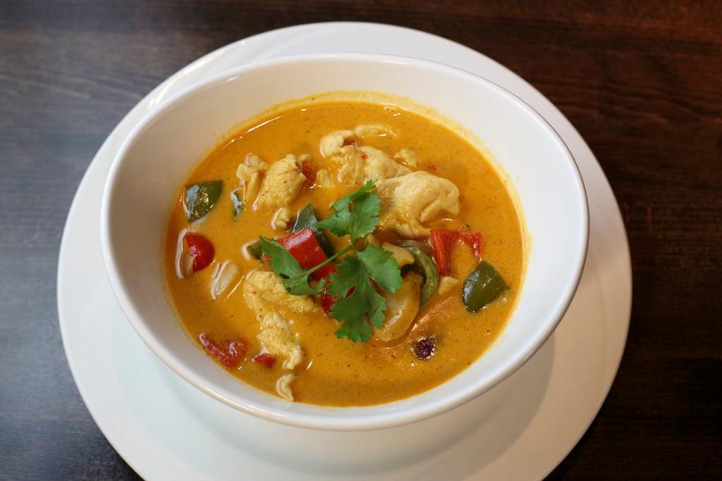 18. Panang Panang Curry · Panang curry with basil, onion, potatoes, bell pepper and coconut milk. Served with tom kah kai soup, salad and steamed rice. Hot and spicy.