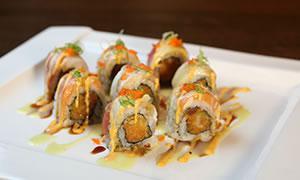 5. Christmas Roll · 5 kinds of fish on top of spicy tuna roll with masago and scallion on the top.