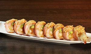 8. Dinosaur Roll · Shrimp tempura, spicy tuna, avocado wrapped with soy paper with spicy crab meat on top with miso and eel sauce.