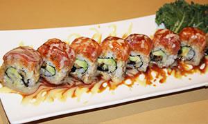 22. Mikado Roll · Eel, avocado inside, spicy crunchy tuna, tuna and salmon on the top.