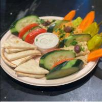 Hummus Trio · Traditional hummus, roasted red pepper hummus, and hatch green chili hummus. Served with veg...