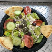 Greek Salad · Traditional Greek salad served with cucumber, tomato, stuffed grape leaves, red onion, feta ...