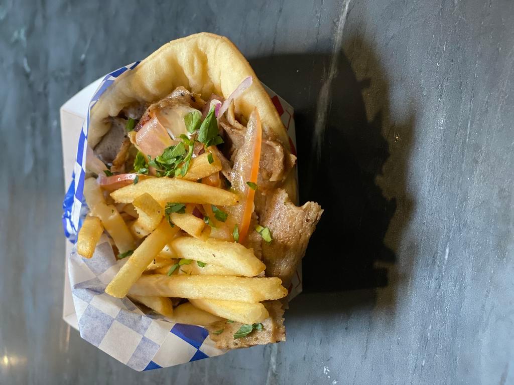 Traditional Gyro Sandwich · Americano. Lamb and beef gyros meat served with tomato, onion, feta, tzatziki sauce and topped with fries.