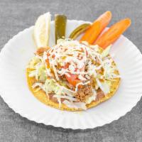 Tostada · Your choice of meat, cilantro, salsa, cheese, lettuce, tomatoes and sour cream.
