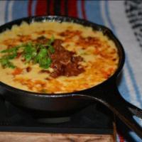 Queso Fundido · Mexican fondue made with a blend of Mexican cheeses served with corn or flour tortillas, sal...