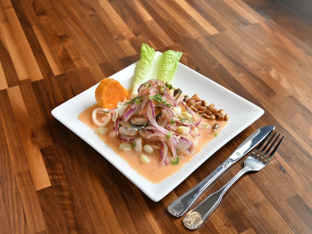 Ceviche Mixto · Peruvian style – sliced fish, shrimp, octopus, squid, and mussels marinated in lime juice, served with sweet potatoes, onions, and toasted corn.