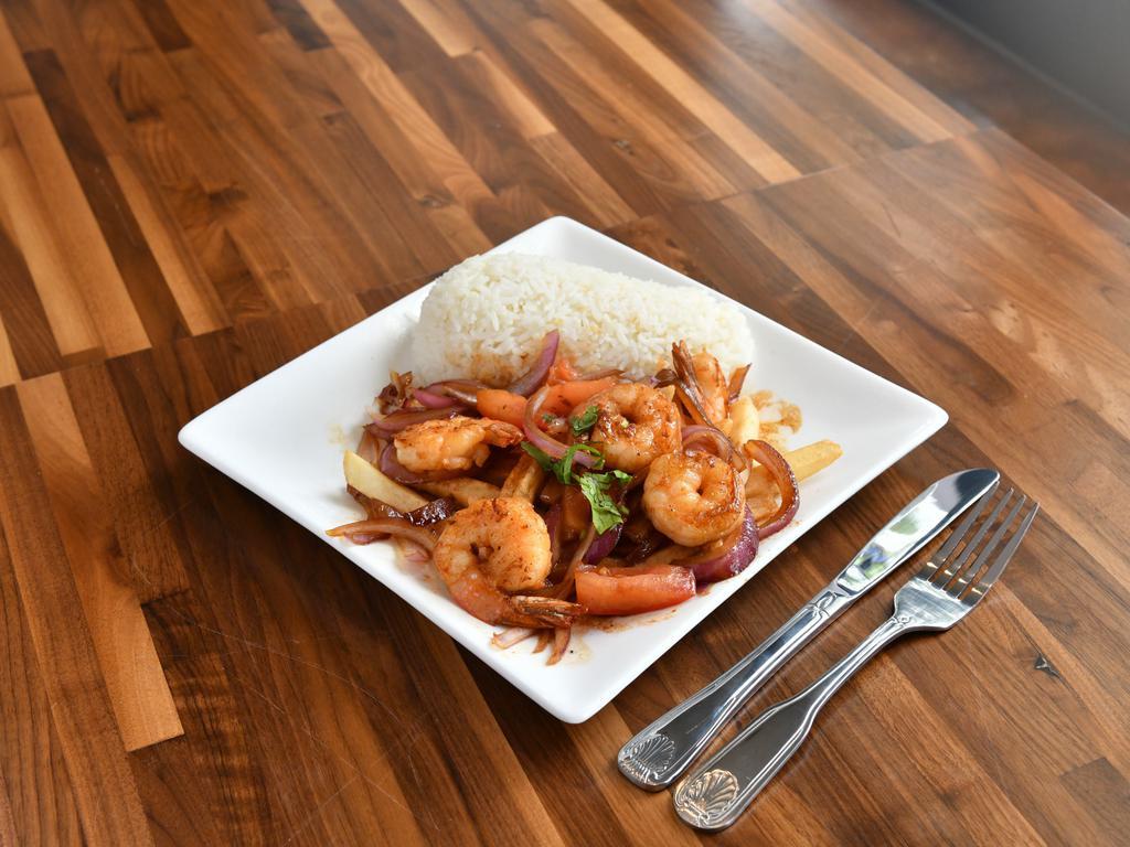 Camaron Saltado · Shrimps sauteed in onions, tomatoes, cilantro, french fries, and soy sauce served with jasmine rice.