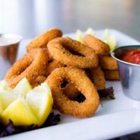 Calamari · Deep fried to perfection and served with a side of marinara and spicy ranch.