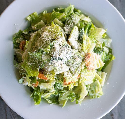 Caesar Salad · Crisp romaine and garlic croutons tossed in a sharp cheese Caesar-style dressing. No anchovies.