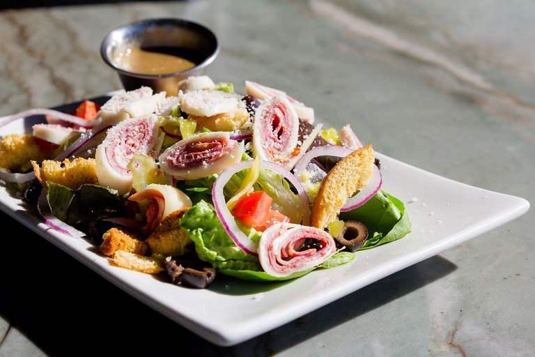 Antipasto Salad · Mixed greens, ham, salami, provolone cheese, sliced tomatoes, olives, pepperoncini, red onions, croutons and Parmesan cheese with Italian dressing.