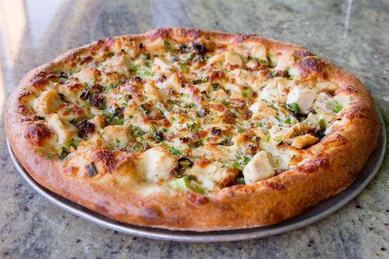 Santa Fe Chicken Pizza · Roasted chicken, red onions, mixed bell peppers, fresh cilantro and spicy Santa Fe cream sauce.