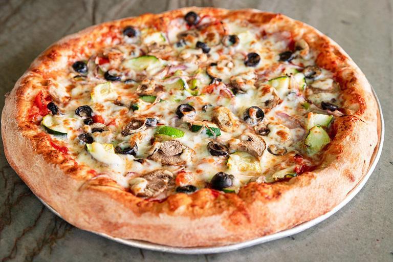 Vegetarian Pizza · Tomato sauce, mozzarella, parm oregano mix, green bell peppers, black olives, mushrooms, onions and zucchini.