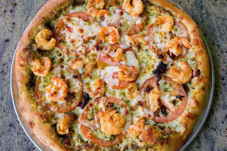 Shrimp Pesto Seafood Pizza · Seasoned shrimp, fresh tomatoes, sun-dried tomatoes and pesto sauce.