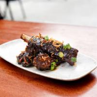 sticky ribs · slow cooked pork ribs served with Sticky BBQ sauce, fried onions, sesame seeds & scallions 
