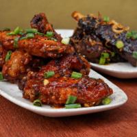 House Crispy Chicken Wings(6pc) · Tossed wings in our house nanban chili sauce(mild), scallions, sesame, seven spice.