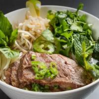 Braised Angus Brisket Pho · Braised beef short rib in 5 spice beef broth, topped vegetables and herbs over rice noodles....